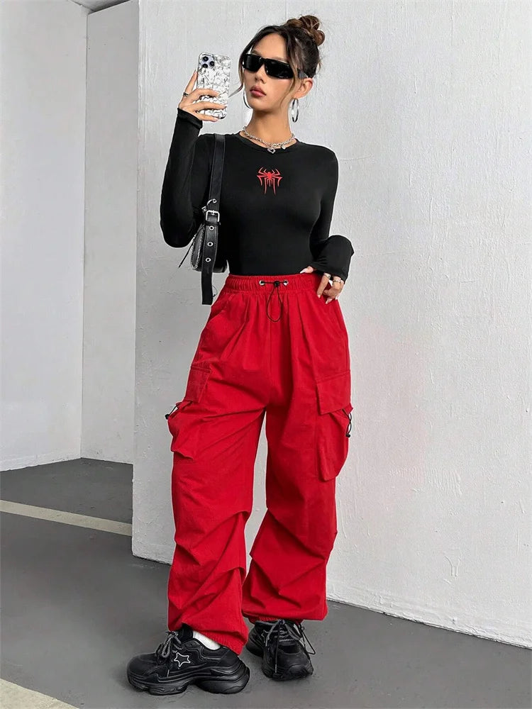 Black spider print crop top with long sleeves worn at the gym — Vagabane Arachnita